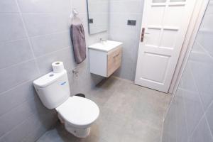 a white bathroom with a toilet and a sink at Dar Simane Aftas in Mirleft +57 photos