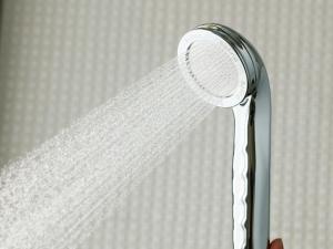 a shower head with water coming out of it at APA Hotel Roppongi SIX in Tokyo