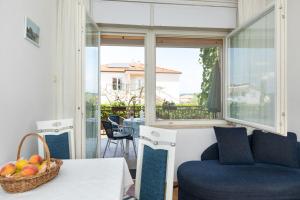 a living room with a couch and a basket of fruit on a table at Apartments Kate in Malinska