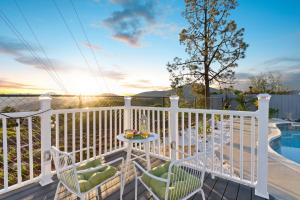 a balcony with a table and chairs and a pool at Upscale Resort House, Views, Saltwater Pool, Spa in Spring Valley