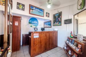 a waiting room with a wooden podium in a room at Cadillac Rock Beach Hotel in Jacó