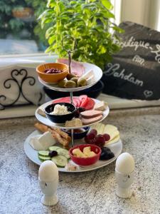 a table with three plates of food and eggs at Boutique Hotel Am Bahndamm in Wallendorf +27 photos
