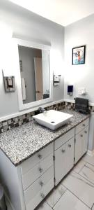 a bathroom with a sink and a mirror at Coloful - Cozy - 1-BR & Sofa-bed in Waukegan