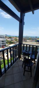 um pátio com uma mesa e cadeiras em uma varanda em Pousada Al Mare em Bombinhas