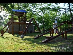a park with a playground with a slide at Cabañas misueño in Villa Ciudad de America