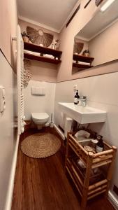 a bathroom with a sink and a toilet at Apartment am Schloss - FLAIR in Saarbrücken +21 photos