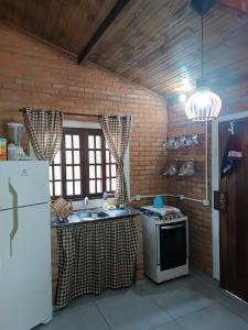 Kuchyň nebo kuchyňský kout v ubytování Chalé Mandala de Pedra