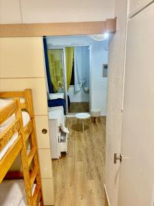 a bedroom with a bunk bed and a mirror at Studio Chaleureux au Cap d’Agde in Cap d'Agde