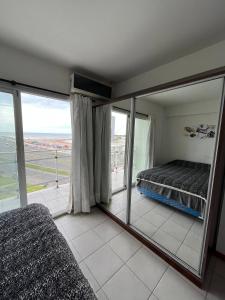 a bedroom with a bed and a large mirror at Colibri MDQ in Mar del Plata
