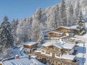 a lodge in the snow with snow covered trees at Kitz Hills Chalet Mondschein in Kitzbühel