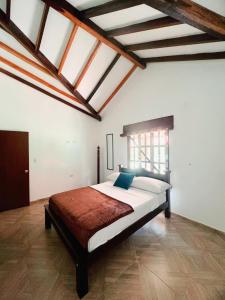 a bedroom with a large bed in a room with skylights at Cabaña La Sanguina 4 Pax in Ocaña +31 photos