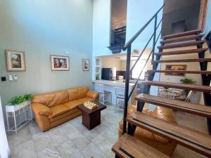a living room with a couch and a staircase at depa del Oso in Nuevo Casas Grandes