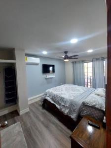 a bedroom with a bed and a flat screen tv at depa del Oso in Nuevo Casas Grandes +54 photos