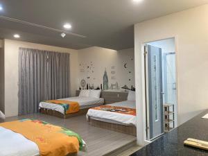 Postel nebo postele na pokoji v ubytování 安可的家 小孩及寵物免費 恆春老街夜市 屏東縣民宿0497