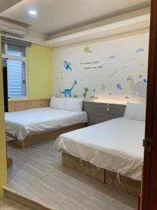 Postel nebo postele na pokoji v ubytování 安可的家 小孩及寵物免費 恆春老街夜市 屏東縣民宿0497