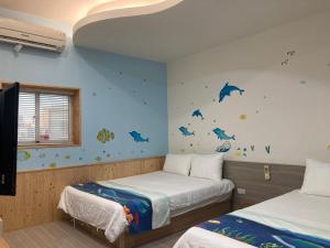 Postel nebo postele na pokoji v ubytování 安可的家 小孩及寵物免費 恆春老街夜市 屏東縣民宿0497
