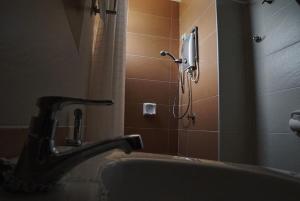 a bathroom with a shower and a sink and a phone at D'PrinceDream in Port Dickson +16 photos
