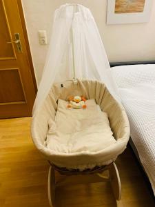 a baby swing in a bedroom with a bed at Ferienwohnung Juttchen in Roßleben