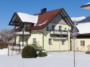 a house with a snow covered roof at K3 Ferienhaus in Strobl