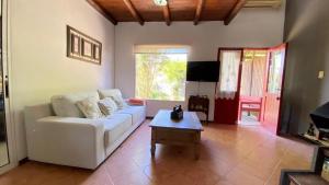 a living room with a white couch and a coffee table at Capricornio 2 in Punta del Este
