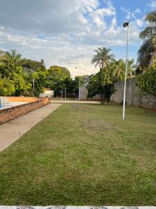 a park with a light pole in the grass at Chácara da Acácias in Sao Jose do Rio Preto