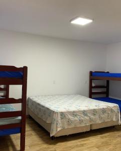 a bedroom with a bed and two bunk beds at Chácara da Acácias in Sao Jose do Rio Preto +11 photos