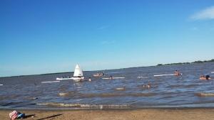 a group of people in the water at the beach at Abuela Chiquita in Ramallo +4 photos
