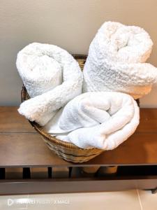 two towels in a basket on a table at The Ecru Suite in Lapu Lapu City