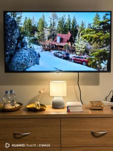 a tv on top of a dresser with a television on it at The Ecru Suite in Lapu Lapu City +59 photos