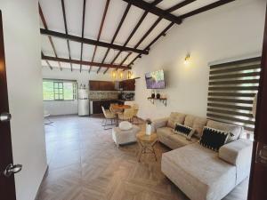 a living room with a couch and a table at Cabaña La Sanguina 8 Pax in Ocaña