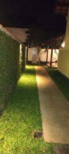 a walkway in front of a building at night at Casa da Pitanga Lumiar in Lumiar