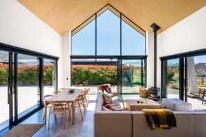 ワナカにあるCoco Chalet by Sotheby's Luxury Rental Homesのソファとテーブルのあるリビングルーム