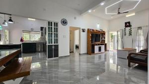 a large living room with a kitchen and a living room at Uthuppan's 2 bedroom first floor in Ūdumbanshola