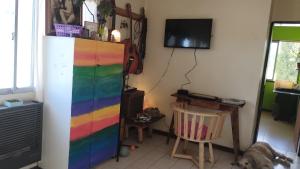 a room with a rainbow colored refrigerator and a dog at Habitación en casa de familia in San Carlos de Bariloche