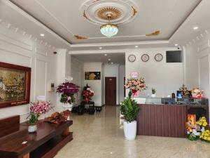 a lobby of a flower shop with vases of flowers at Eco BMT LUXURY HOTEL in Buon Ma Thuot
