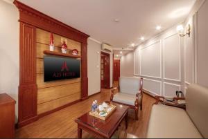 a living room with a couch and a tv at A25 Premium Hotel - 23 Quán Thánh in Hanoi