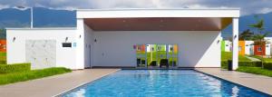 a pool in front of a white building with a swimming pool at KIRAz in Turín
