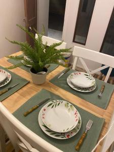 a table with plates and a plant on it at Cabañas Torres del Sol in Vicuña