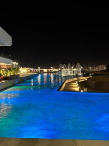 - une grande piscine d'eau bleue la nuit dans l'établissement Scilia casa vacanza, à Palerme