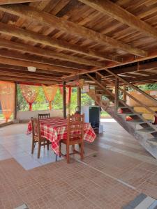 a dining room with a table and chairs in a house at Village Nature Les Balisiers in Roura +16 photos