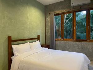 Postel nebo postele na pokoji v ubytování COCO HOME Homestay(โคโค่โฮม)