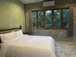 Postel nebo postele na pokoji v ubytování COCO HOME Homestay(โคโค่โฮม)