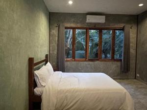 Postel nebo postele na pokoji v ubytování COCO HOME Homestay(โคโค่โฮม)