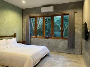 Postel nebo postele na pokoji v ubytování COCO HOME Homestay(โคโค่โฮม)