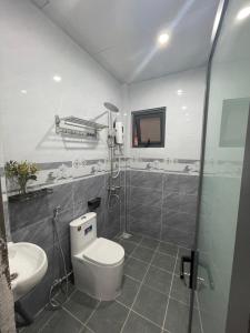 a bathroom with a toilet and a sink and a shower at Thương Thương Homestay in Xuan An +50 photos