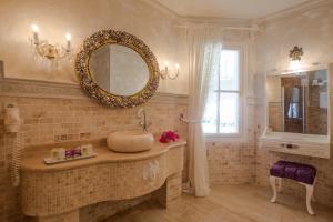 a bathroom with a sink and a mirror at Lukka Exclusive Hotel – Adult Only +12 in Kaş