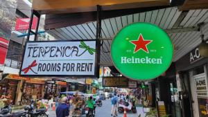 a sign for a store in a shopping street at Terpenica - Rooms for Rent in Pattaya South