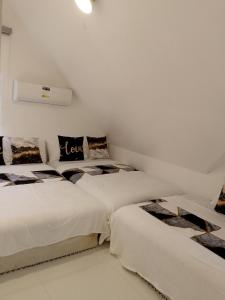 two beds in a room with white walls at Montalban Villa in General Trias +41 photos