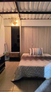 a bedroom with a bed with a wooden wall at House Viotá in Viotá