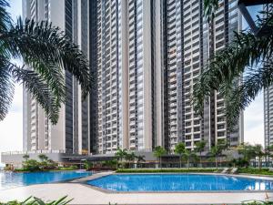 an apartment complex with a swimming pool in front of tall buildings at 慕海Mosea悠享海景三卧房4806 in Johor Bahru
